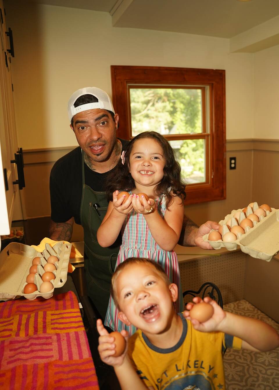 Derek Ellis with his kids and a carton of eggs