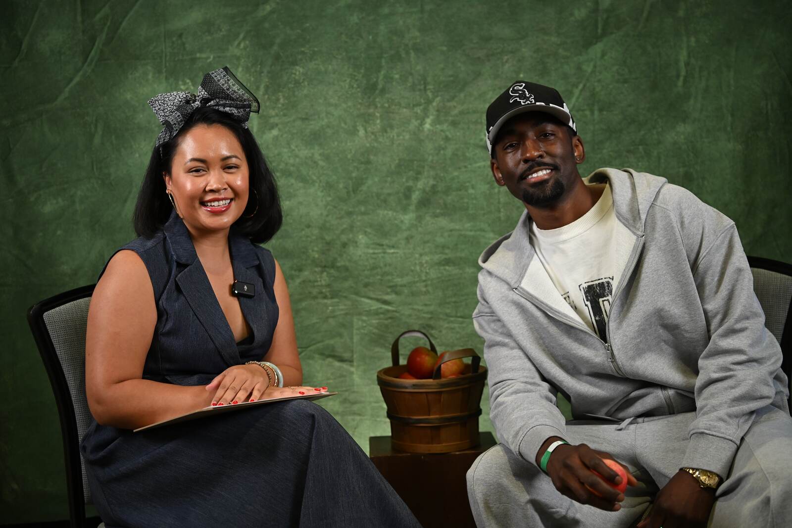 Sina War interviews a guest on the Grow Your Green set